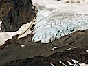 Some glacier moving down a mountain